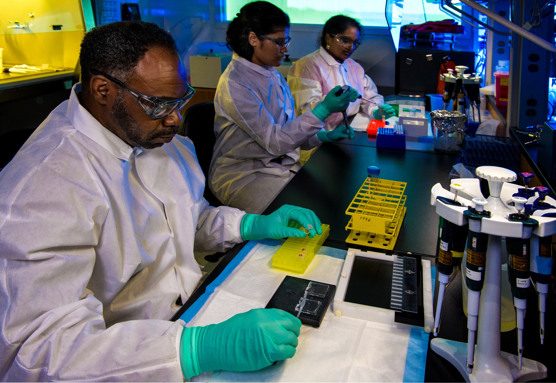 researcher filling yellow container at lab